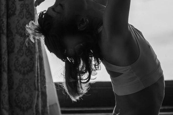 Stylized silhouette of a person in a strong warrior yoga pose.